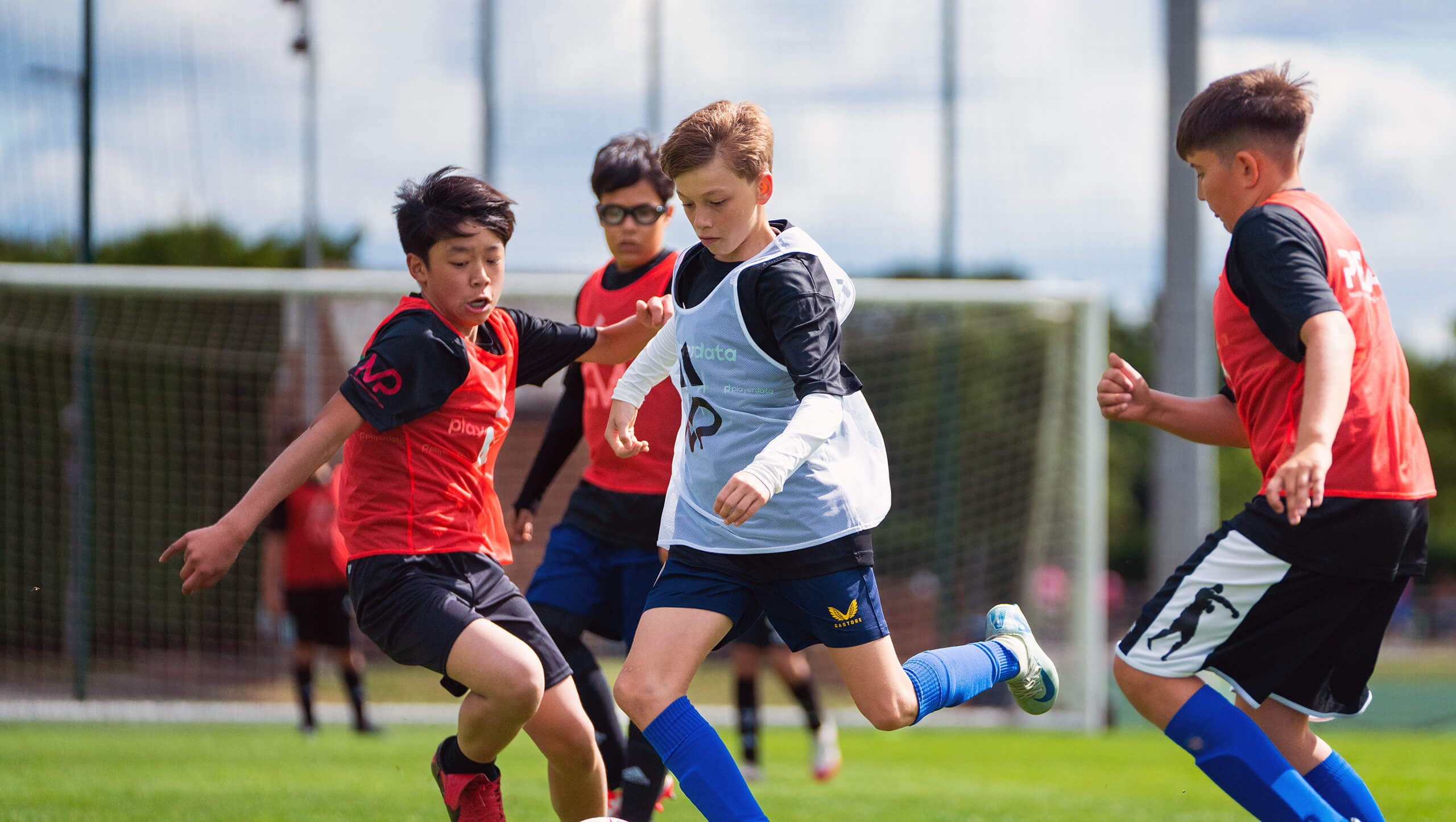 Boys competing in a football game at the MP Coaching Football Camp.